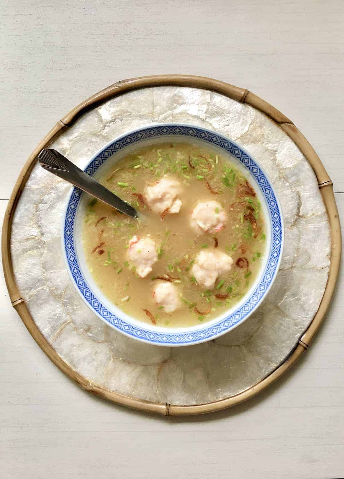 A bowl of vegan asian wonton soup with vegetarian balls