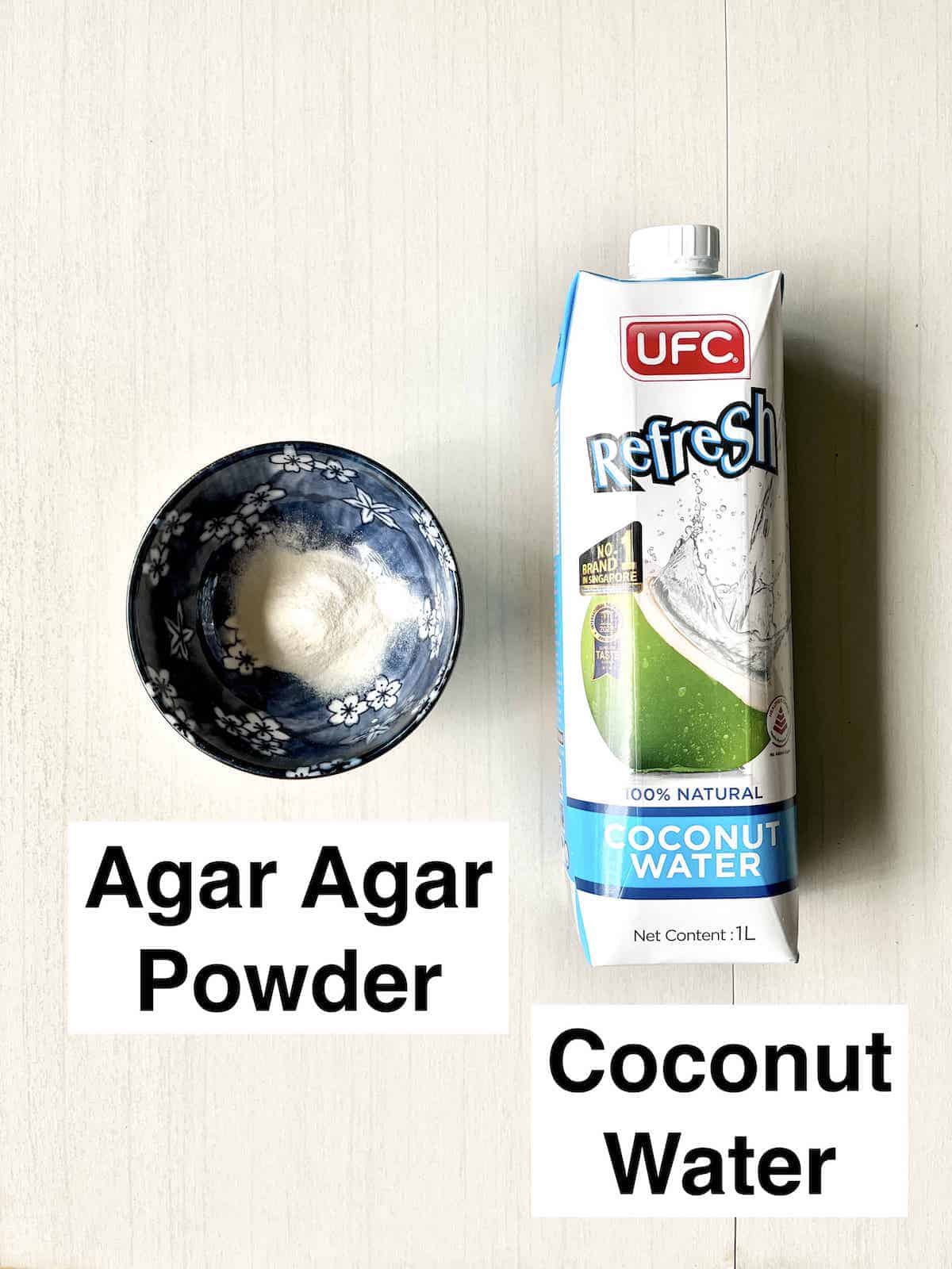 A bottle of coconut water next to a bowl of agar agar powder.
