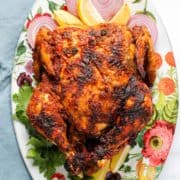 An orange tandoori whole roast chicken