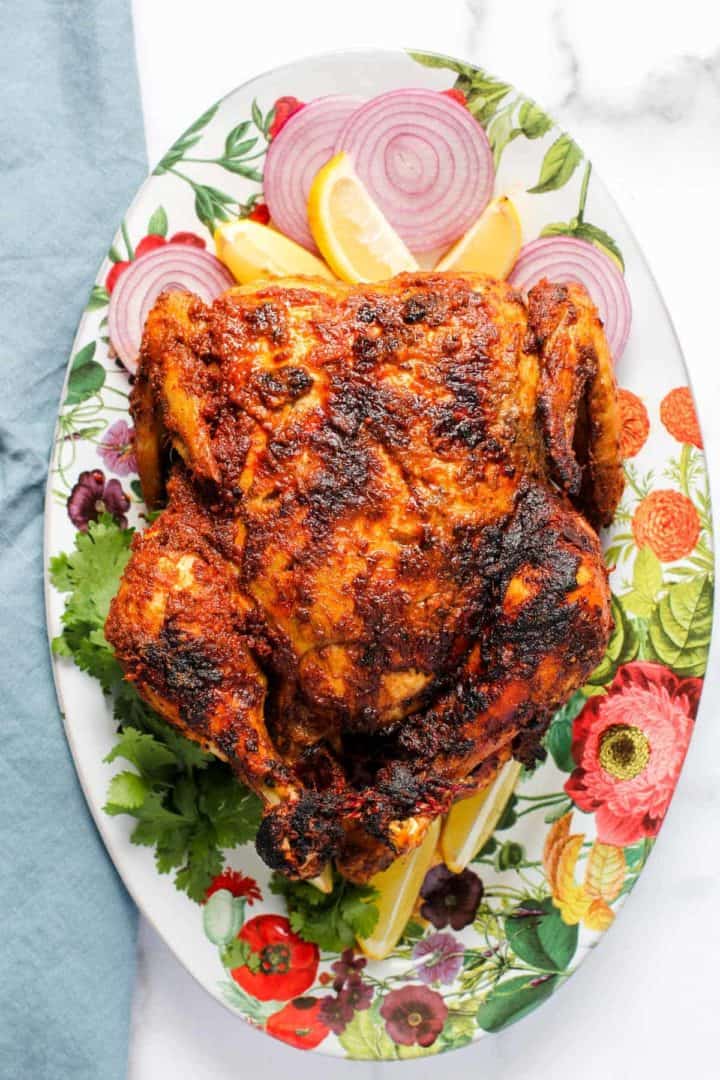 An orange tandoori whole roast chicken