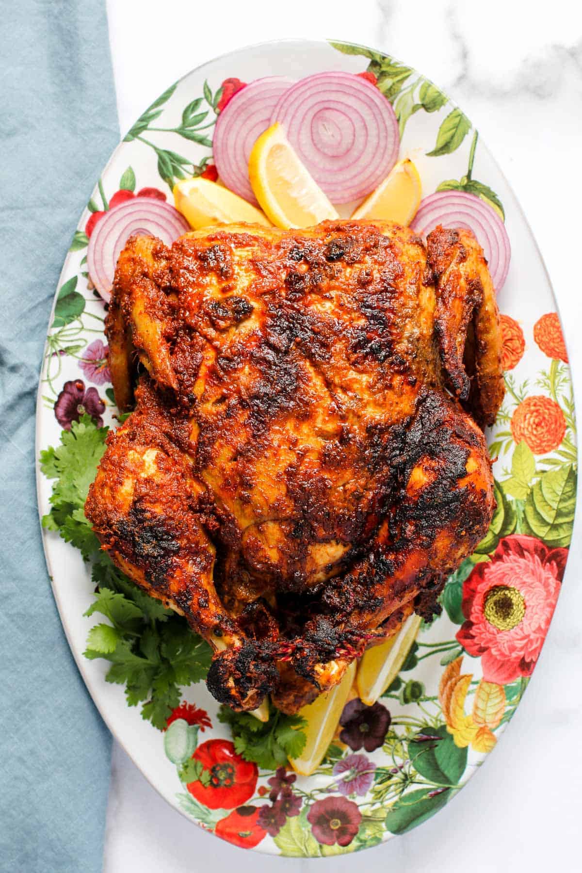 An orange tandoori whole roast chicken