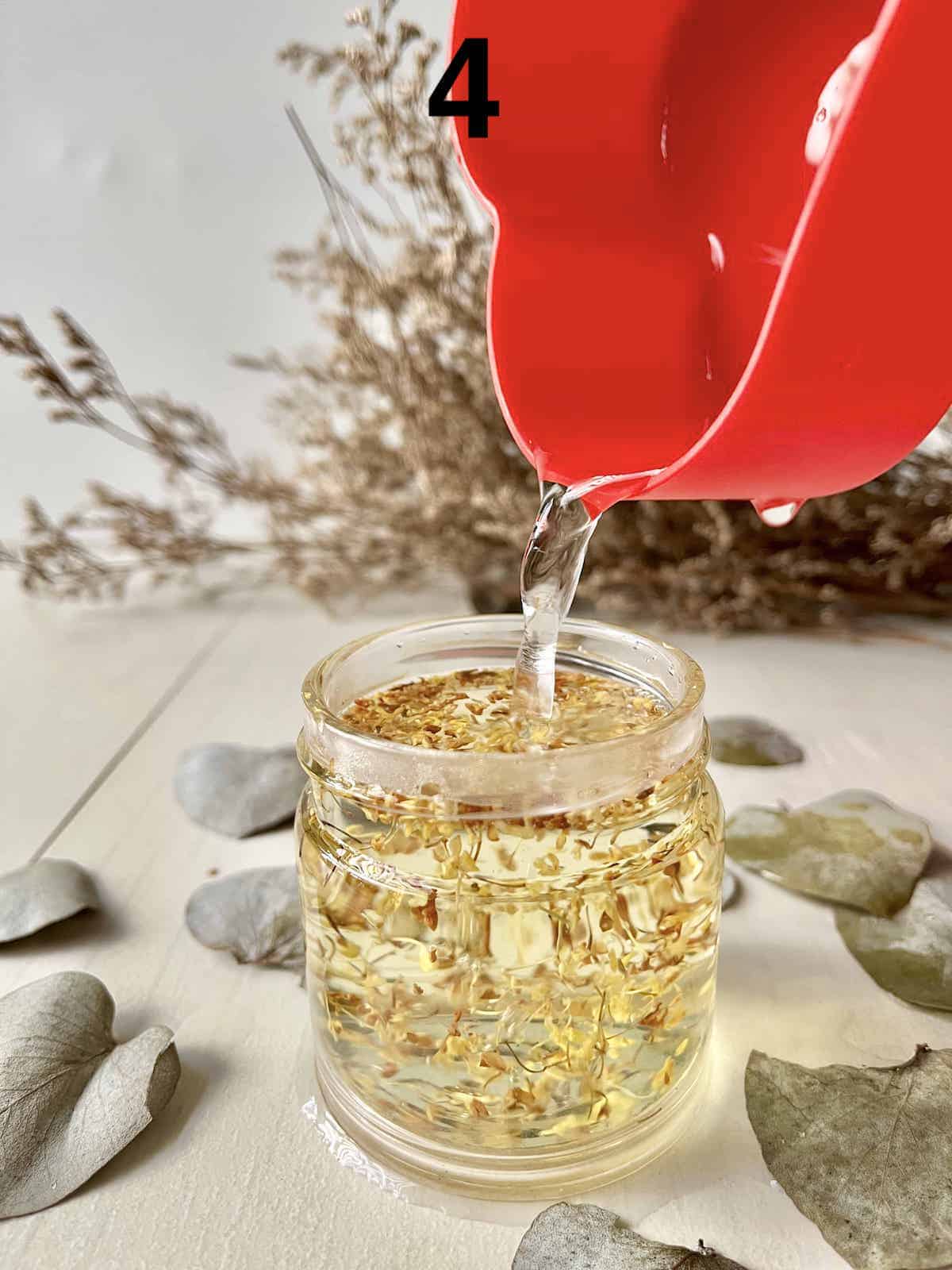 Pouring hot water over the washed osmanthus flower buds.