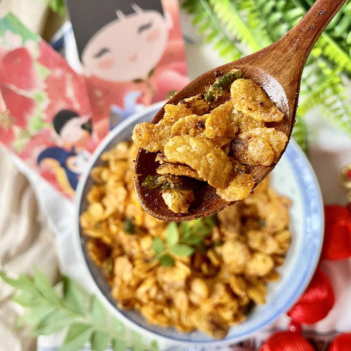 A wooden spoon full of crunchy salted egg yolk cereal.