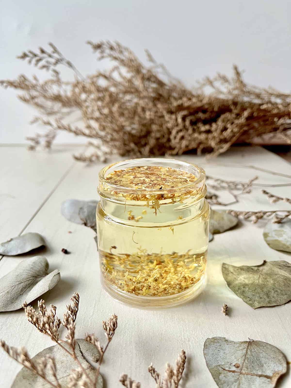 Brewing osmanthus herbal tea in a glass cup.