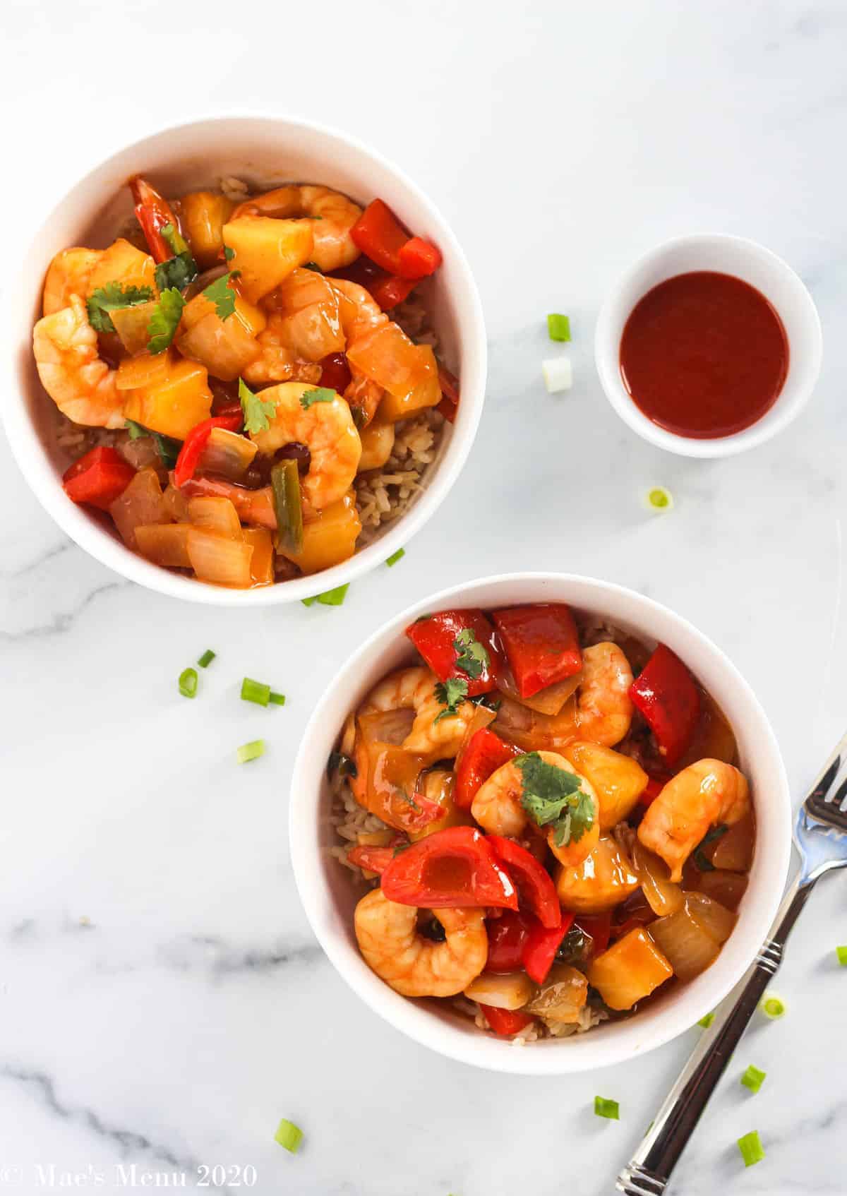 2 bowls of sweet and sour shrimp with pineapple