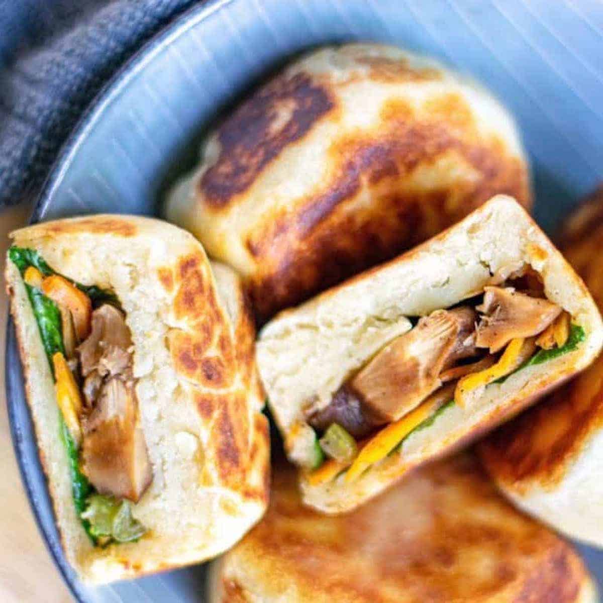 Close-up of Chinese vegetable buns in a blue bowl.