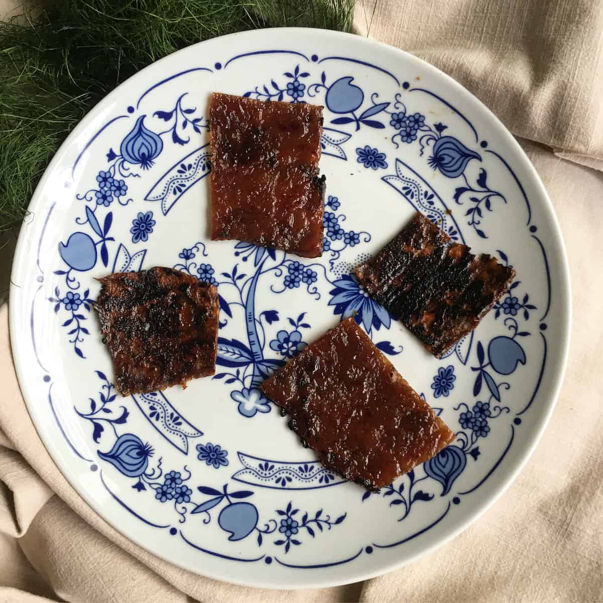 Mushroom vegan jerky and pork bak kwa side by side on a plate