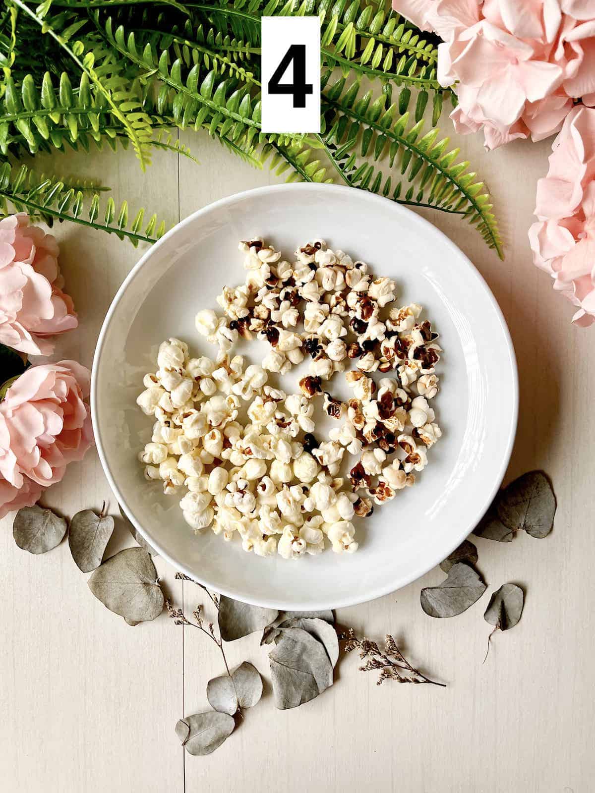 2 types of salted stovetop popcorn on a white plate.