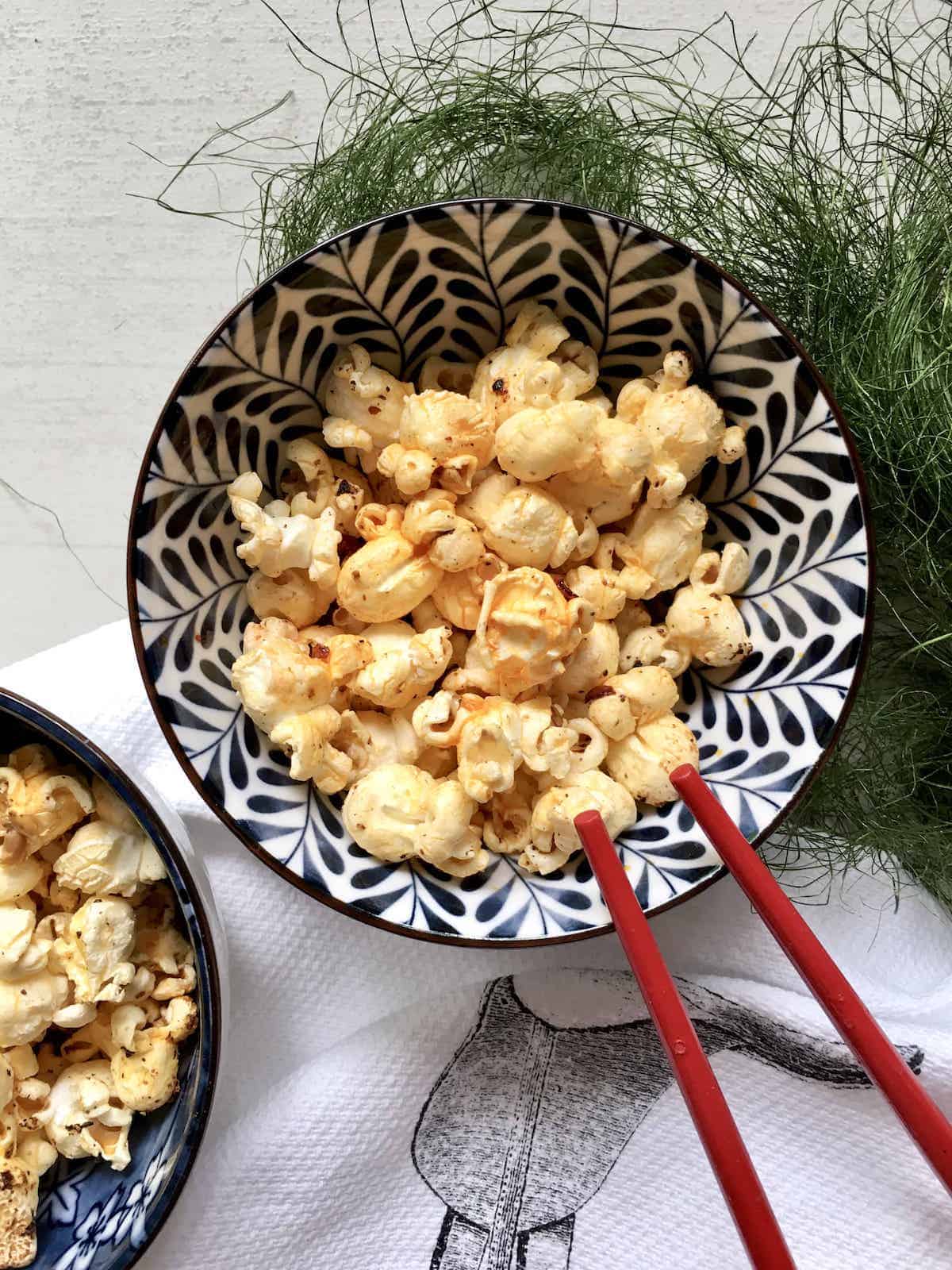 A bowl of spicy red popcorn made with chilli oil