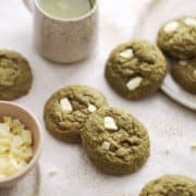 Several green matcha cookies spread on a table