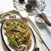 Mushrooms on a fancy white serving platter.