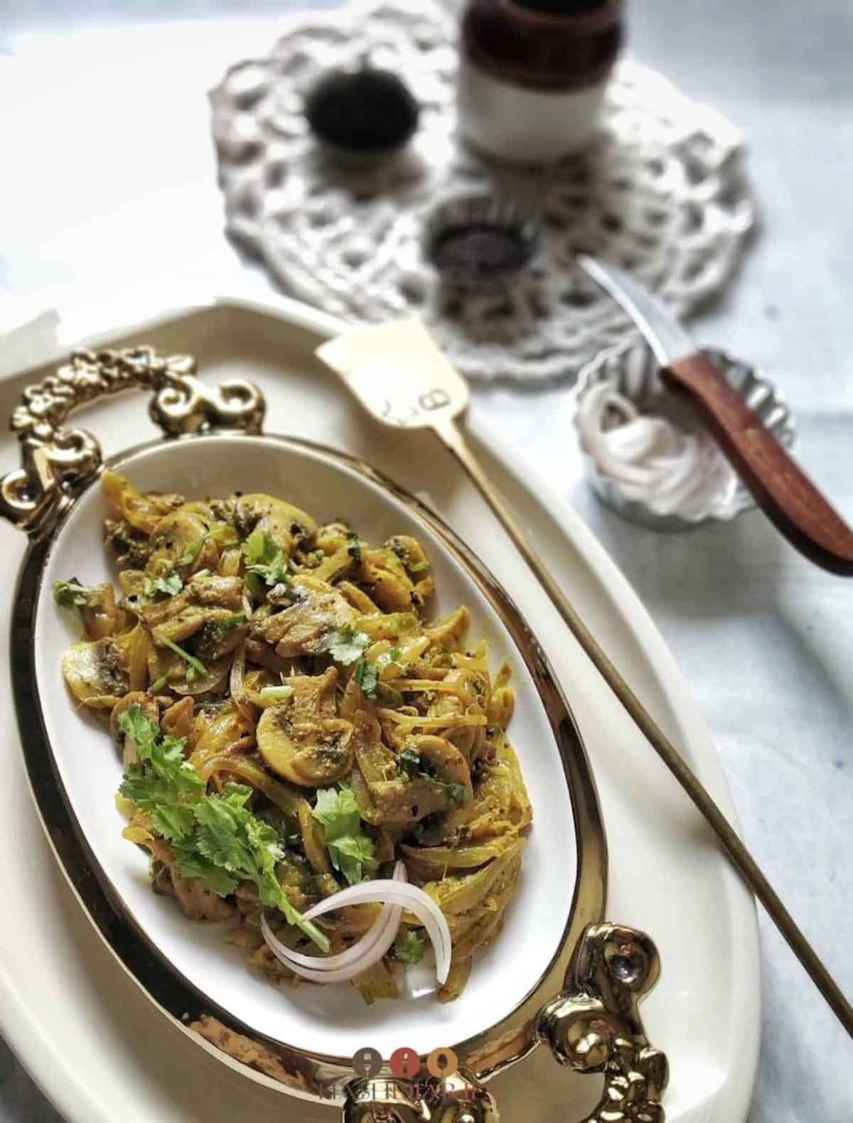 Mushrooms on a fancy white serving platter.