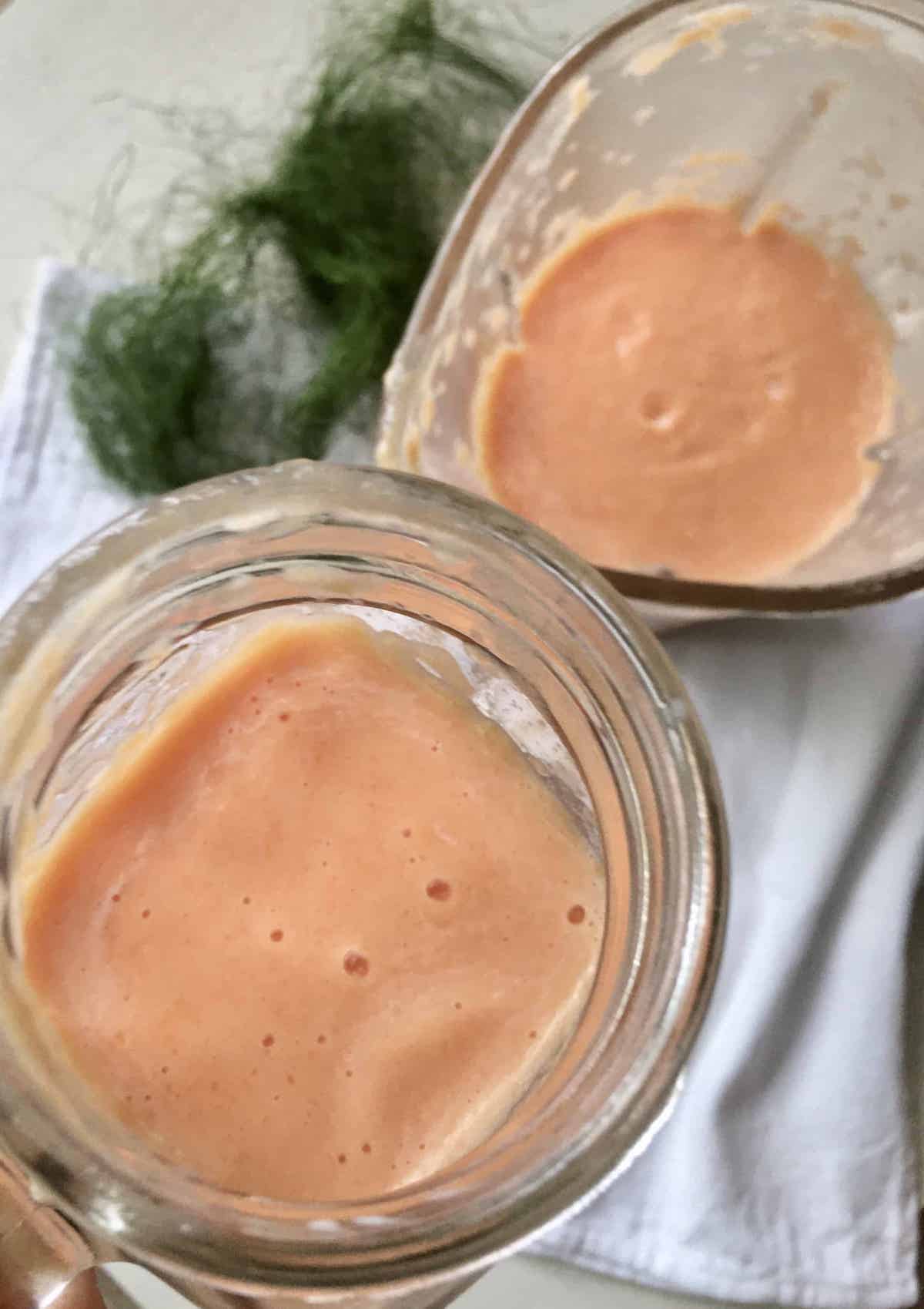 A glass of papaya milk with bubbles on top