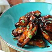 Honey, tamari and coriander wings on a blue platter