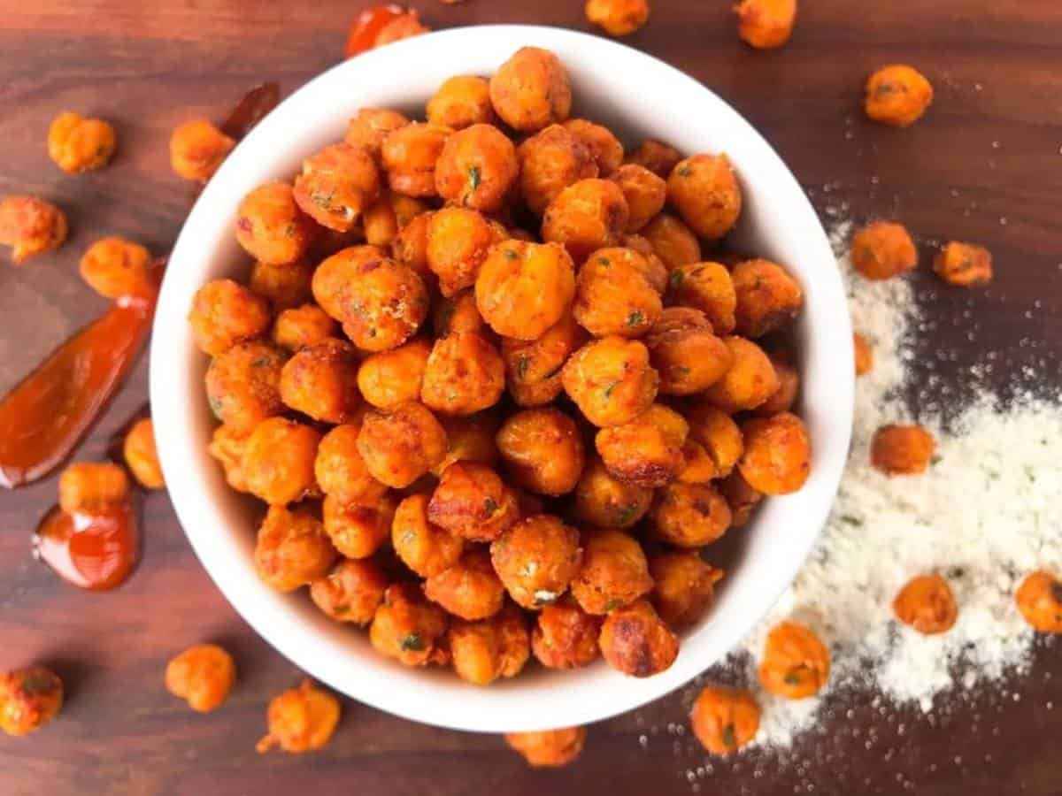 Red roasted chickpeas overlowing in a white bowl