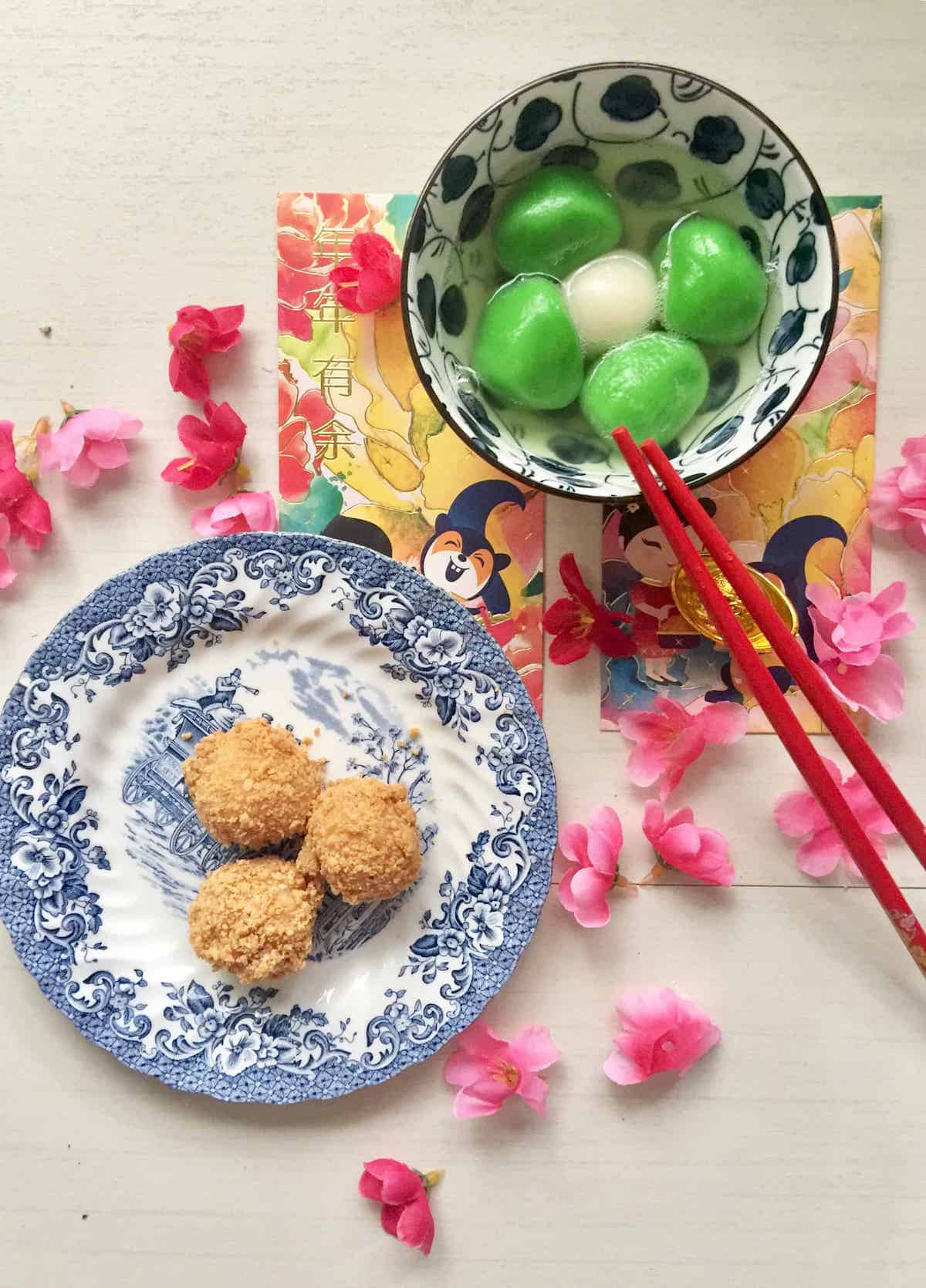 A plate of peanut coated tang yuan with sesame filling next to a bowl of tang yuan in soup