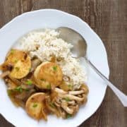 A plate of rice with egg tofu and mushrooms.