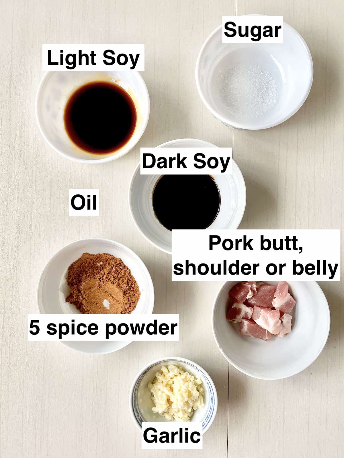 The ingredients needed for Singaporean Tau Yew Bak in bowls next to each other.