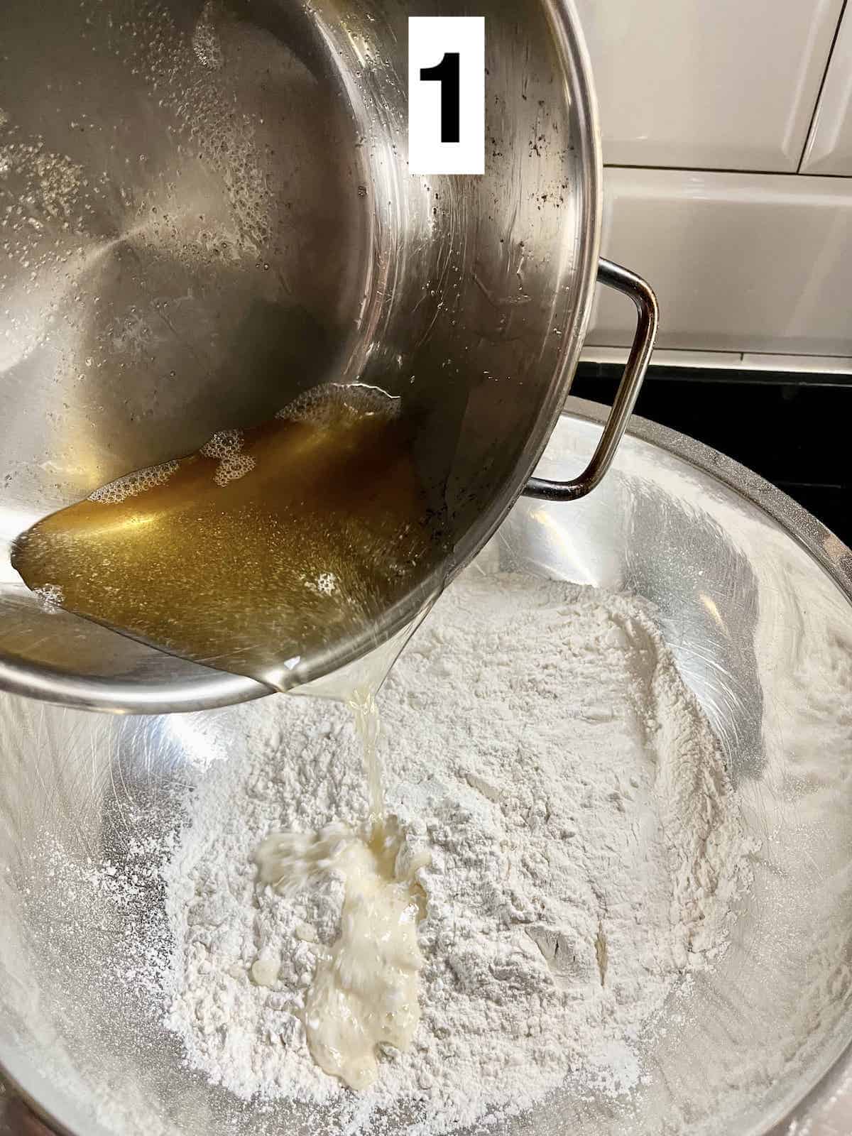 Pouring hot oil into flour for curry puff dough.