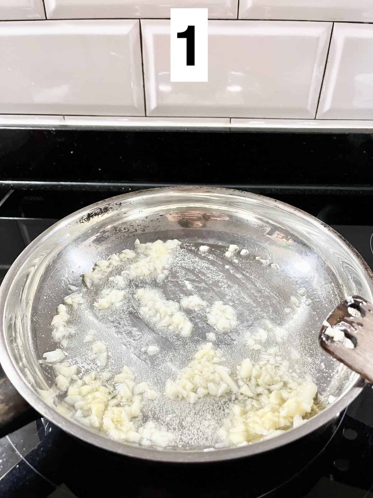 Sauteeing minced garlic in lard.