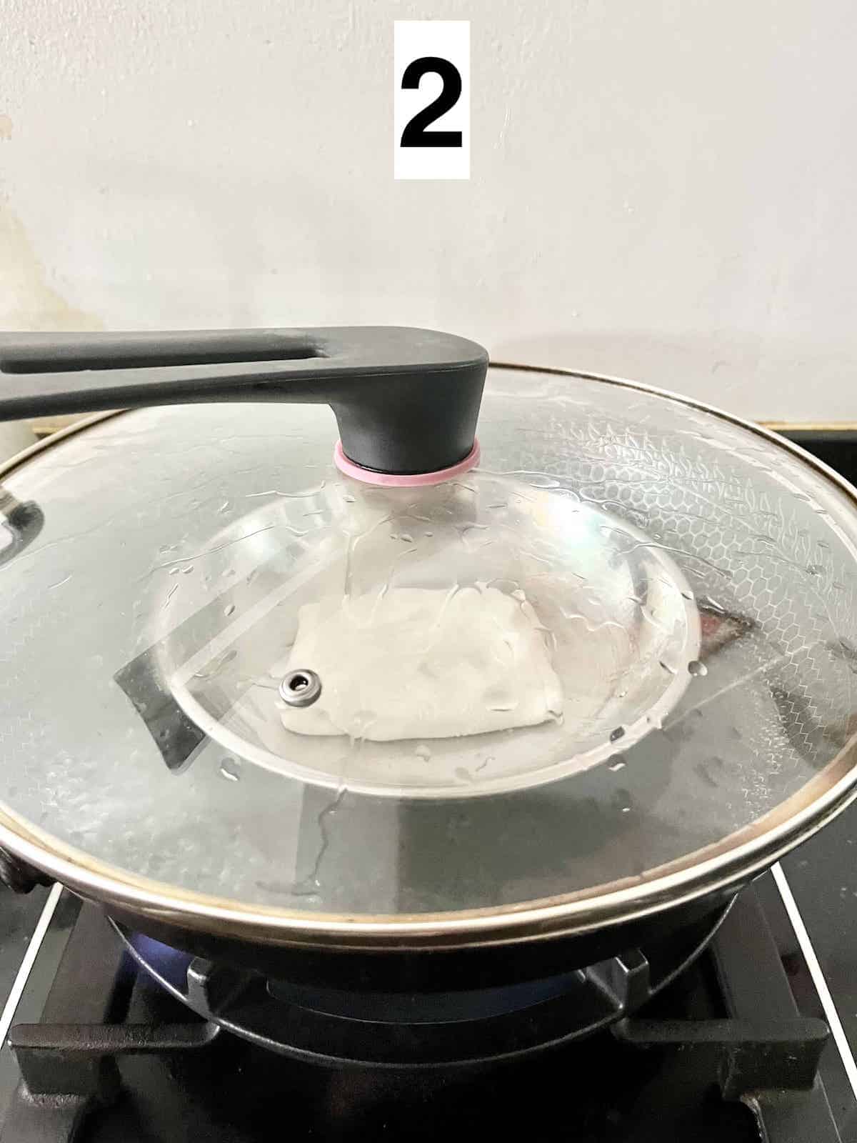 Steaming glutinous rice flour dough in a wok.