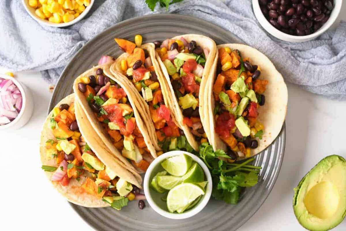 4 gluten free tacos with black beans on a plate