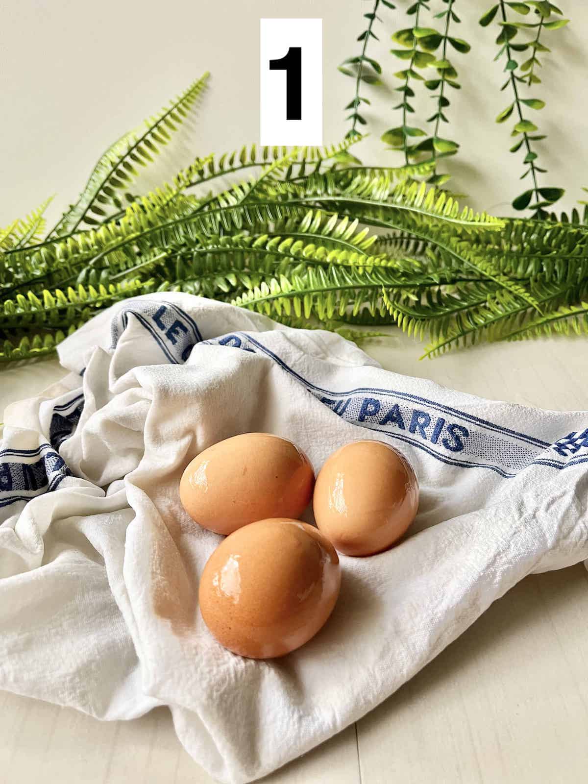 Wet eggs on a Le Creuset tea towel.