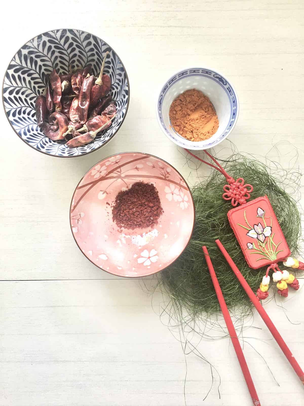 A bowl of dried chillies, gochugaru Korean chilli flakes and Chinese chilli powder.