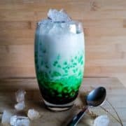 Glass of white and green cendol drink.