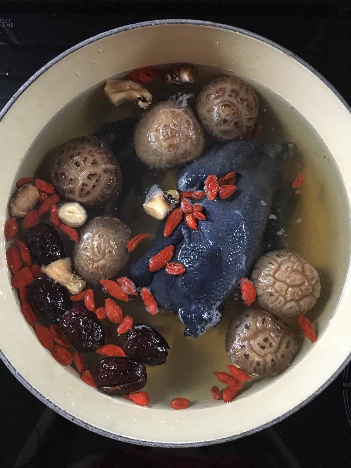 Black chicken soup and all the ingredients in a pot before boiling.