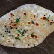 A piece of naan that was made on the stove.