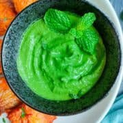 Close-up of a bright green Indian mint sauce.