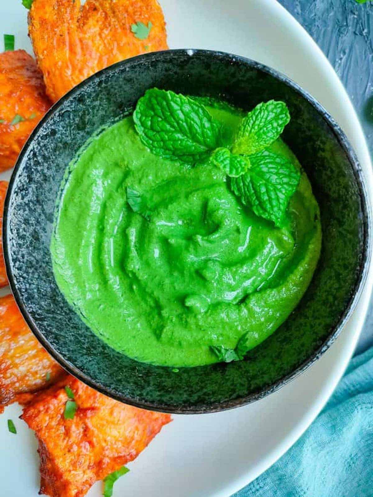 Close-up of a bright green Indian mint sauce.