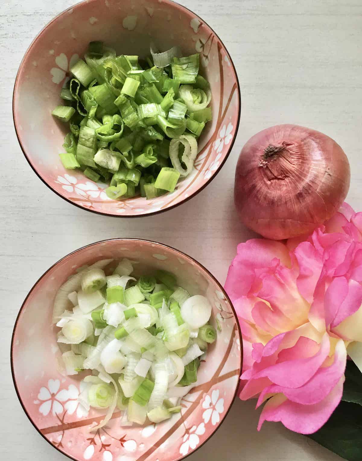 2 bowls of sliced spring onions, divided into the green and white parts.