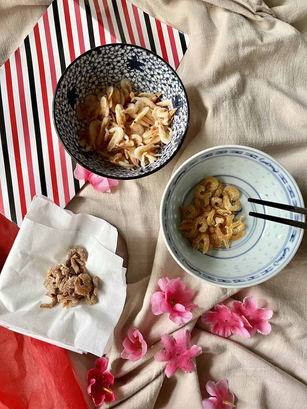 A bowl of dried shrimp next to a bowl of spoilt dried shrimp and a bowl of Sakura Ebi.