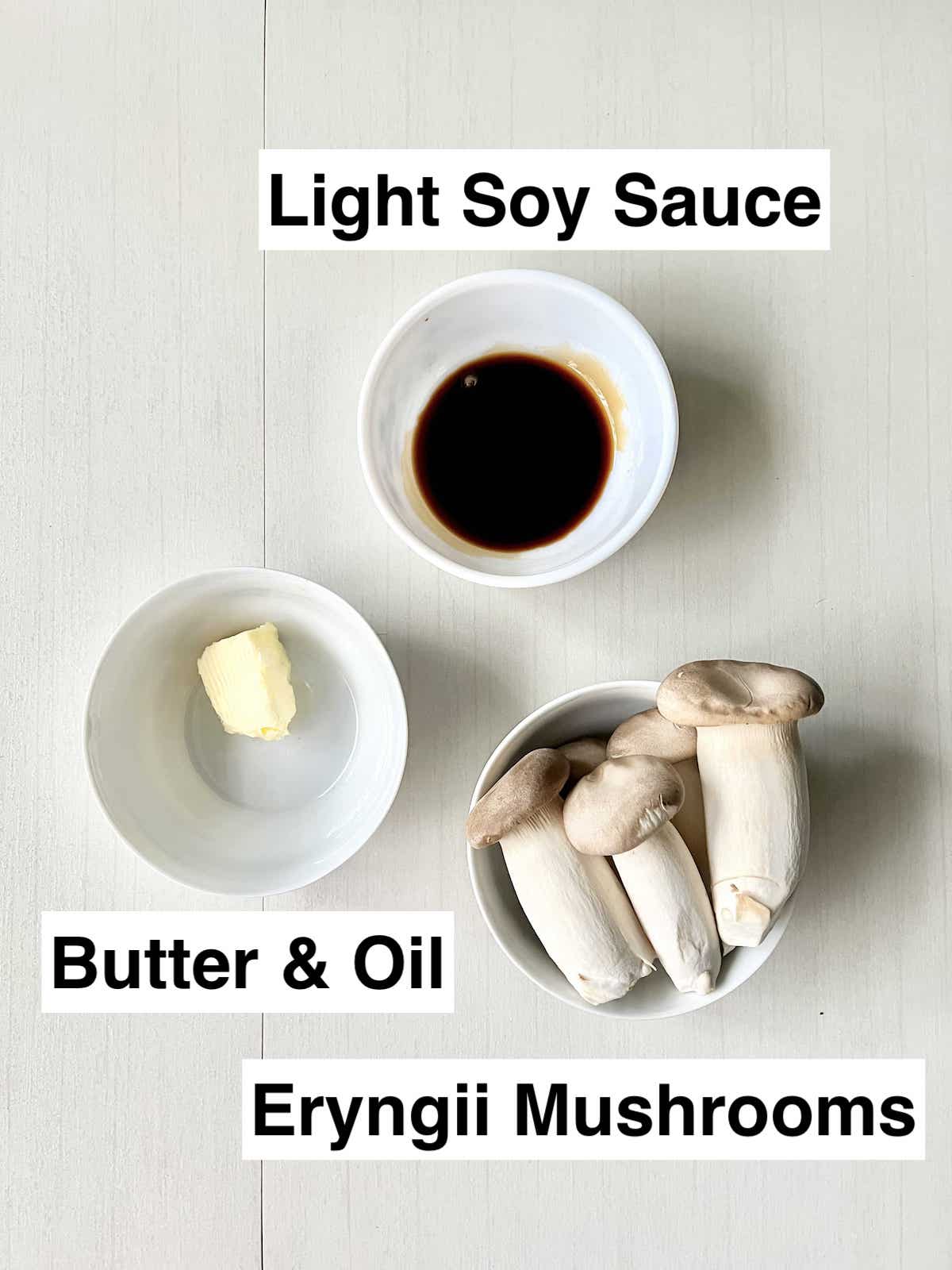 A bowl of butter, light soy sauce and eryngii mushrooms next to each other.