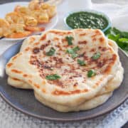 Peshwari naan on a grey plate.