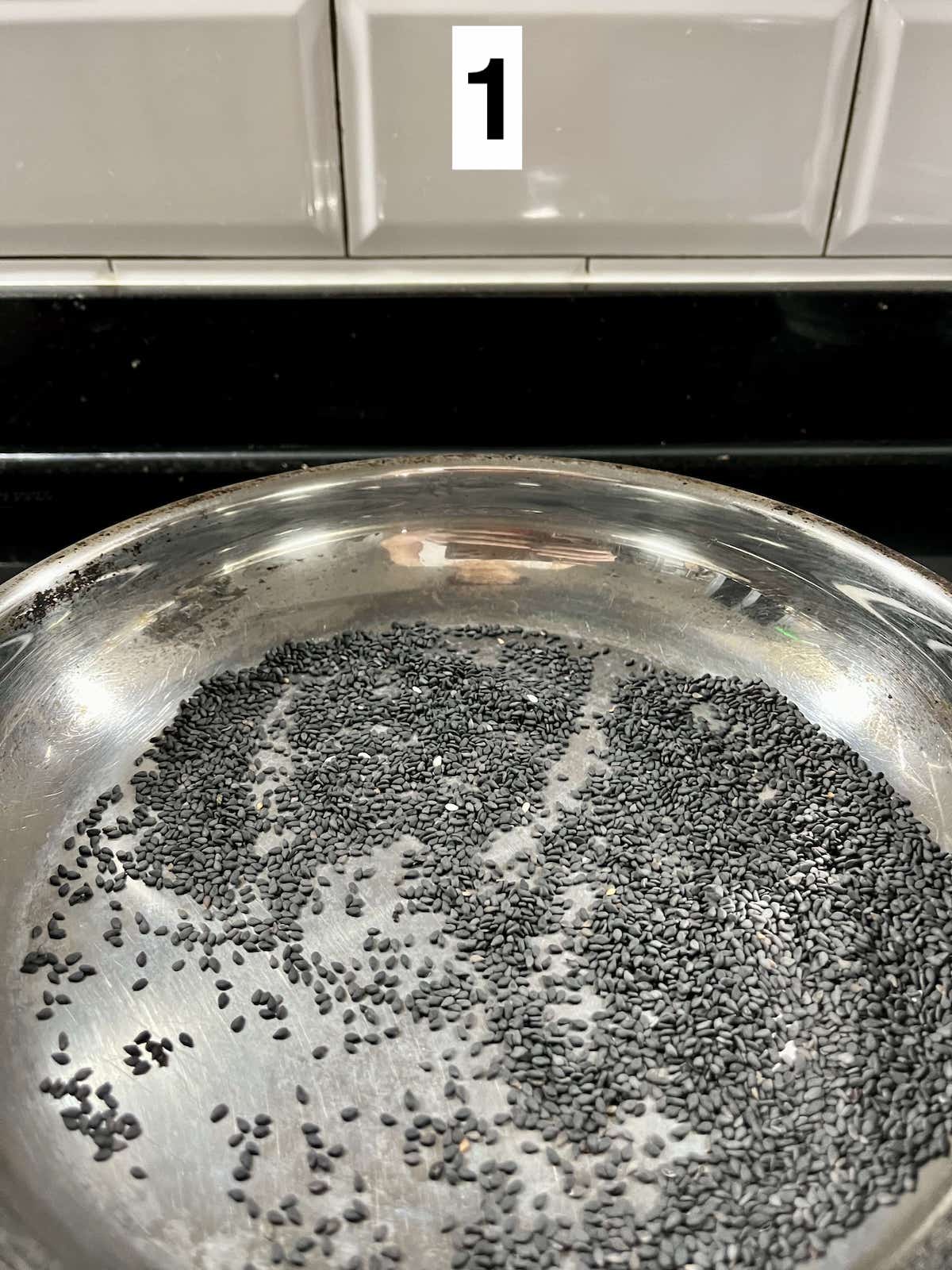 Dry frying black sesame seeds over low heat.
