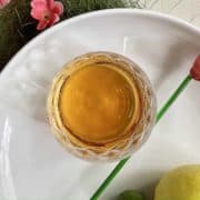 Amber coloured Korean plum wine in a glass.