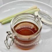 A jar of dark brown lemongrass simple syrup.