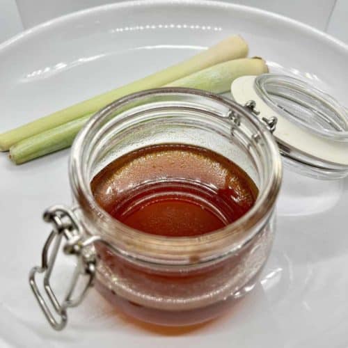 A jar of dark brown lemongrass simple syrup.