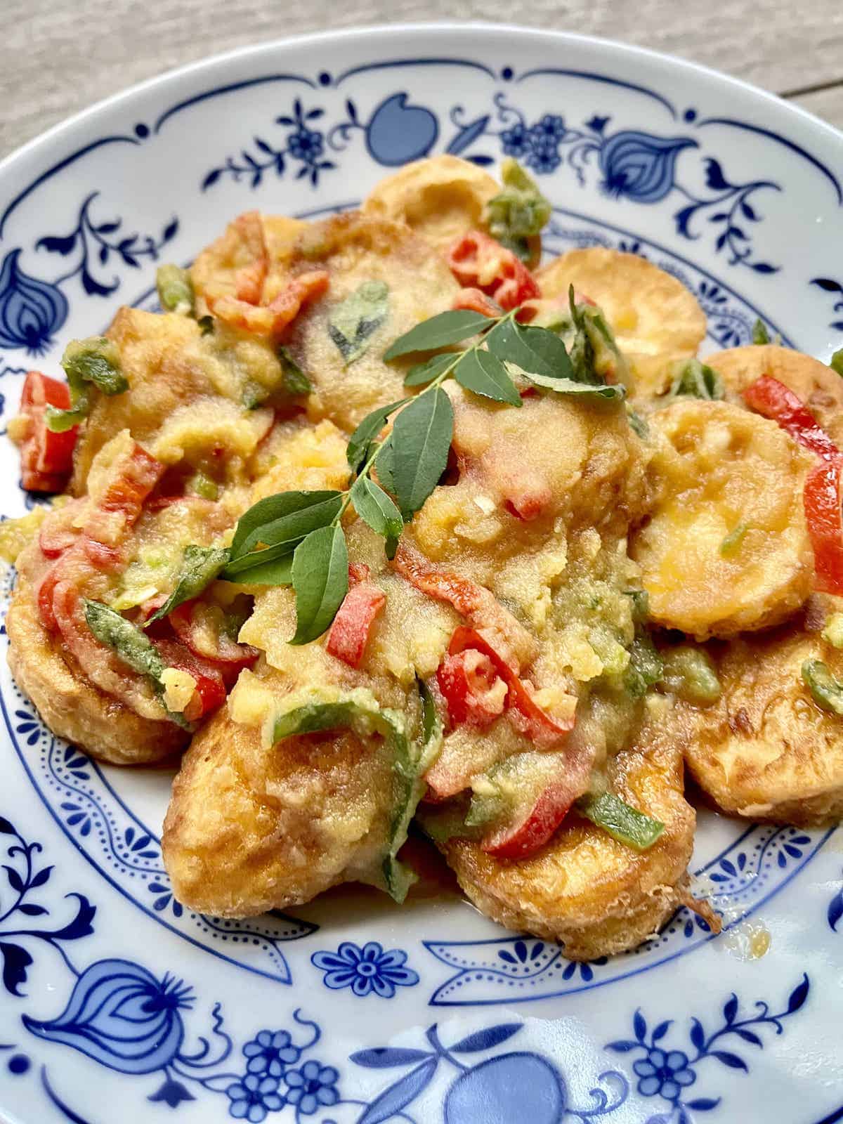 Close up of a salted egg tofu with chilli and curry leaves dish.