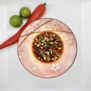 A bowl of garlic and chilli mixed with calamansi lime and soy sauce .