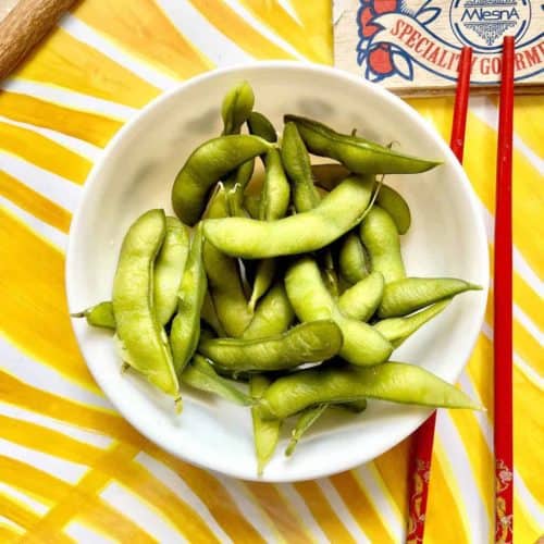 A bowl of boiled edamame beans.
