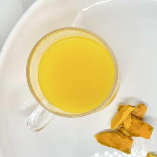 Close-up of naturally golden turmeric, ginger and cinnamon tea.