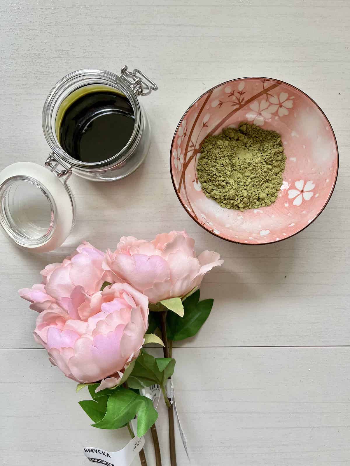 Green tea simple syrup next to matcha powder.