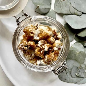 Close-up of soy sauce and butter popcorn in a glass jar.