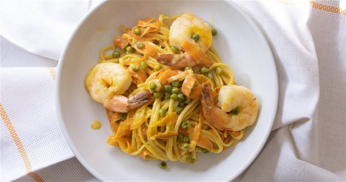 A plate of turmeric prawn linguini pasta.