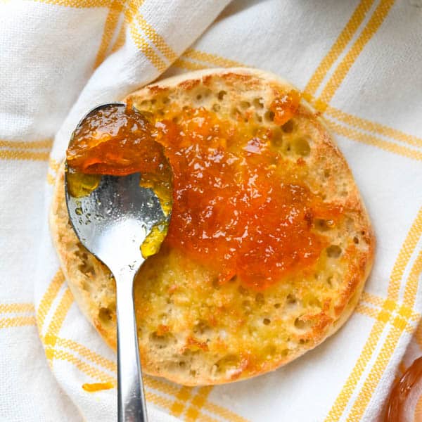 A crumpet with calamansi marmalade spread on it.