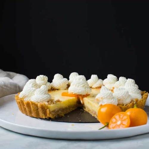 Side view of a calamansi pie tart with white topping.